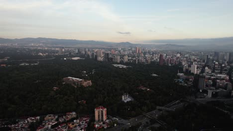 Aerial-view-overlooking-the-Chapultepec-park-and-the-skyline-the-capital-city,-sunny-morning-in-Mexico---circling,-drone-shot
