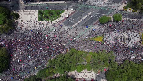 Aerial-view-above-crowded-Reforma-avenue,-during-Gay-pride-parade-in-Mexico-city---cenital,-drone-shot