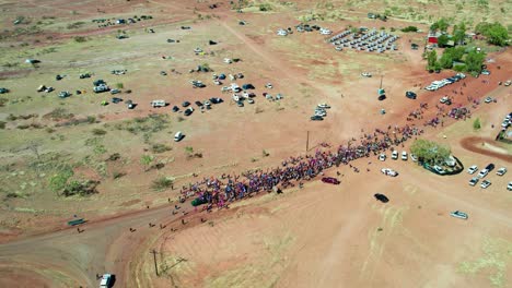 Aerial-view-of-the-crowds-at-the-start-of-the-Freedom-Day-Festival-march-in-the-remote-community-of-Kalkaringi,-Northern-Territory,-Australia