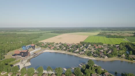 Drone-view-approaching-the-lake-and-water-park-in-the-Resort-Hof-van-Saksen---Nooitgedatch,-in-the-Netherlands