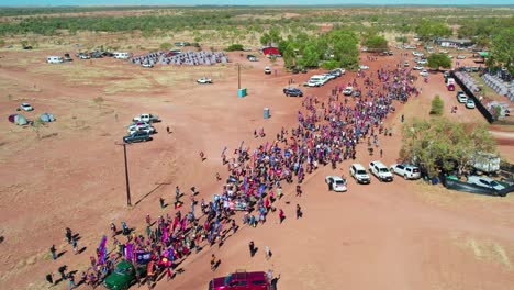 Aerial-view-of-the-start-of-the-Freedom-Day-Festival-march-in-the-remote-community-of-Kalkaringi,-Northern-Territory,-Australia