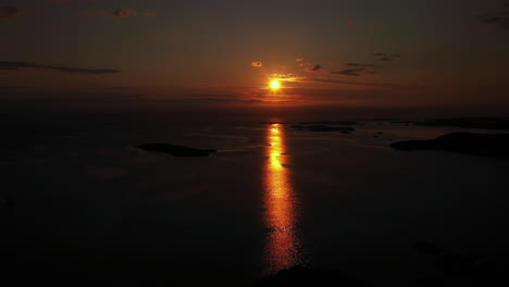 Aerial-view-overlooking-the-silhouette-islands-on-the-coast-of-central-Norway---reverse,-drone-shot