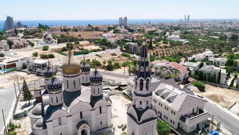 Aerial-drone-footage-of-the-new-Russian-orthodox-church-Saint-Nicholas-in-Limassol,-Cyprus-with-sea-view