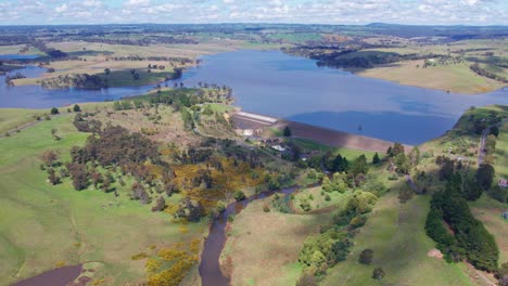 Aerial-view-of-the-Upper-Coliban-Reservoir-dam-wall,-spillway-and-reservoir,-central-Victoria,-Australia