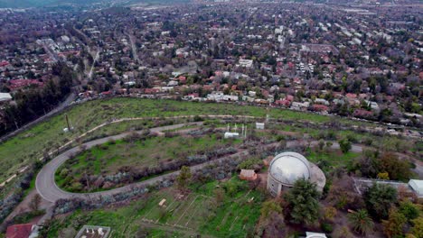 Aerial-view-dolly-in-the-Cerro-Calan-Observatory-Park-in-Las-Condes,-Chile