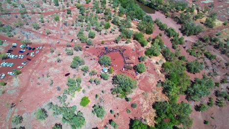 Circling-aerial-view-of-the-cermony-at-the-start-of-the-Freedom-Day-Festival-at-Kalkaringi,-Northern-Territory,-Australia