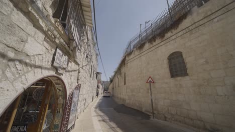 Car-Driving-On-Narrow-Street-In-The-Neighborhood-Of-Beit-Ya'akov-In-Jerusalem