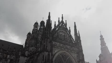 Facade-grim-gray-gothic-sint-jans-cathedral-on-cloudy-day-in-den-Bosch-low-angle-shot