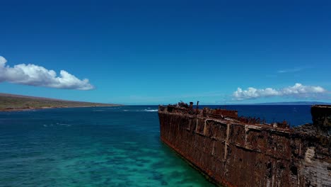 Drone-flight-over-Shipwreck-Beach-with-wrecked-ship-offshore,-Lanai