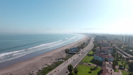 Aerial-orbit-of-the-waterfront-of-La-Serena-full-of-large-houses-with-tile-roofs-and-palm-trees,-Chile