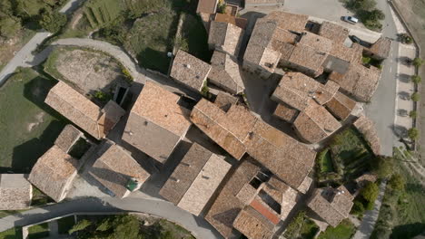 Aerial-orbiting-top-down-descending-over-roofs-of-small-country-village
