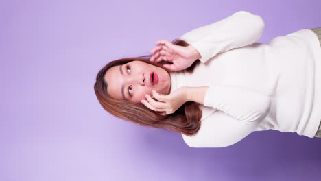 Vertical-of-Young-Asian-women-talk-on-smartphone-technology-to-network-with-clients-or-negotiate-deals-isolated-over-a-violet-background