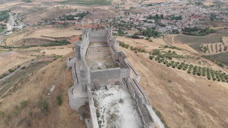 Incredible-aerial-view-of-the-Cid-Castle,-located-on-top-of-a-hill-in-Guadalajara,-Spain