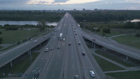 Aerial-shot-of-morning-traffic-on-the-highway-with-on-ramps-to-the-Grota-bridge-over-the-Vistula-River