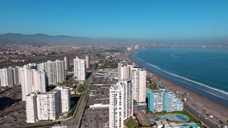 Dolly-in-aerial-view-of-exclusive-buildings-on-the-waterfront-of-La-Serena,-Chile-on-a-sunny-day