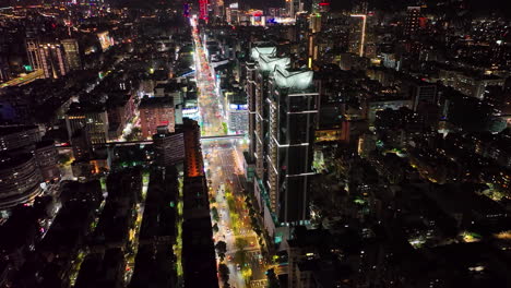 Aerial-night-shot-of-Taipei-towers,-tower-101-and-cars-lights-on-road-at-night,Taiwan
