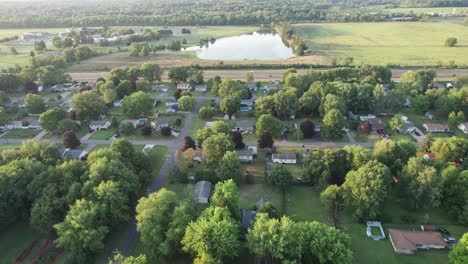 An-aerial-shot-of-residential-neighborhood-near-grassy-park-and-beautiful-lakes
