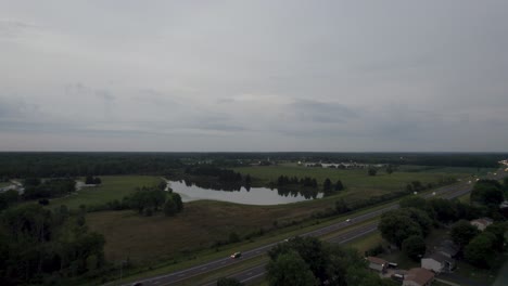 A-drone-shot-of-a-small-lake-surrounded-by-trees-in-a-city