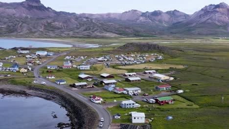Nordic-coastal-town-in-remote-valley-with-residential-buildings,-aerial