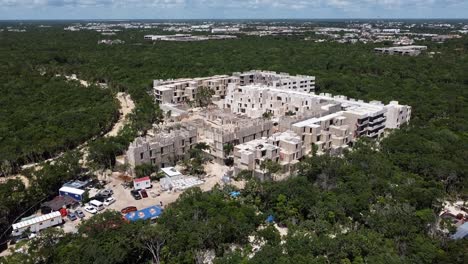 Aerial-of-a-construction-building-site-in-Tulum-Mexico-surrounded-by-jungle