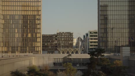 Glass-windowed-skyscrapers-in-Paris-on-a-warm-day,-panning-down-slowly