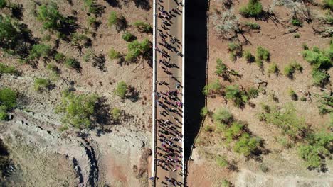 Overhead-drone-view-of-people-in-the-Freedom-Day-Festival-march-in-the-remote-community-of-Kalkaringi,-Northern-Territory,-Australia