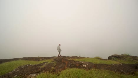 Active-Man-On-Clifftop-During-Foggy-Morning