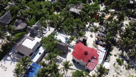 Aerial-of-hotels-along-tropical-beach-coastline-in-Tulum-Mexico-on-sunny-day
