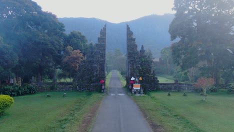 Balinese-landscape-and-ancient-gates-of-Handara,-flying-towards