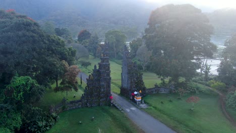Ancient-stone-gates-in-middle-of-jungle-in-Bali,-Indonesia,-aerial-view