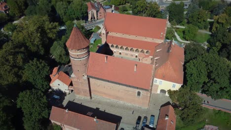 Aerial-footage-of-a-gothic-church-in-Poland,-Slowly-flying-away