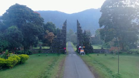 Flying-away-from-majestic-gate-of-Handara-in-Bali-island-during-misty-weather