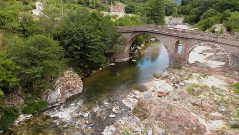 Aerial-4K-shot-of-old-stone-bridge-and-river-Pilima-Xanthi-Greece-1