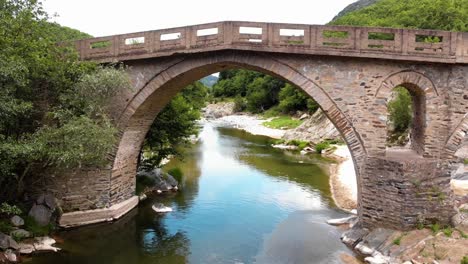 Aerial-4K-shot-of-old-stone-bridge-and-river-Pilima-Xanthi-Greece-3