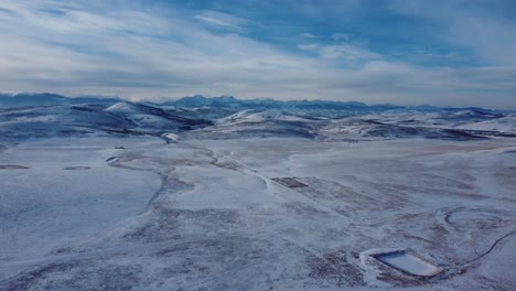 Aerial-shot-of-the-Rocky-Mountains-covered-with-snow-over-winter-time-in-Canada