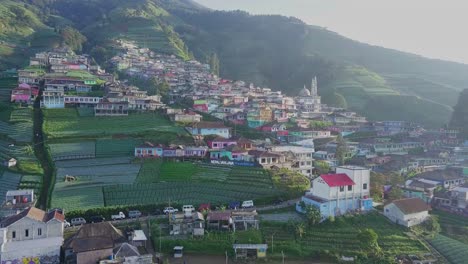 Aerial-footage-of-colorful-village-house-on-the-slope-of-mountain-with-"Nepal-Van-Java"-inscription