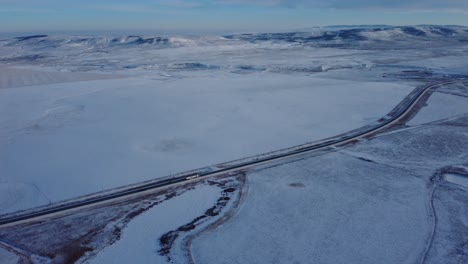 Semi-truck-driving-on-highway-in-winter-time-in-western-Canada-towards-USA-border