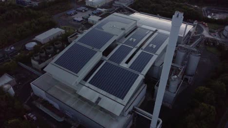 Aerial-descending-Birdseye-view-UK-photovoltaic-solar-rooftop-warehouse-building