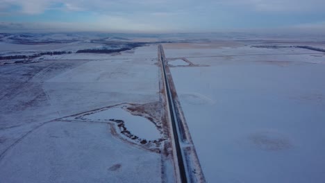 Empty-highway-in-Western-Canada-covered-with-snow-and-ice