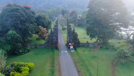 Iconic-ancient-stone-gates-of-Handara-in-Bali-island,-aerial-orbit-view-during-bright-sunshine