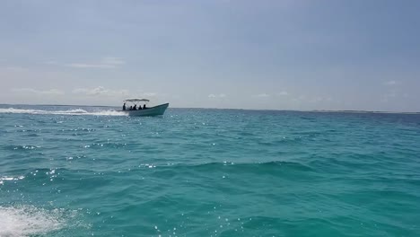 Pov-watch-motor-boat-sailing-on-blue-water-sea,-sunset-adventure-caribbean-sea