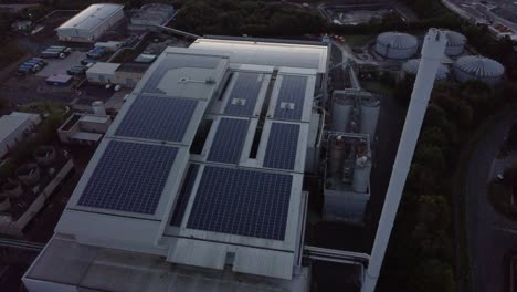 Aerial-Birdseye-view-orbiting-UK-solar-rooftop-renewable-energy-factory-power-station