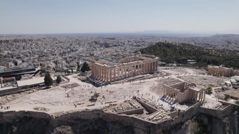 Archaeological-remains-Acropolis-of-Athens,-ancient-citadel-located-on-a-rocky-outcrop-above-the-city-of-Athens,-aerial
