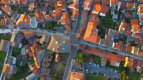 Aerial-Birds-Eye-View-Over-Orange-Coloured-Rooftops-In-O-Grove-In-Galicia-at-sunset