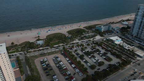 Aerial-View-of-Pompano-Beach-FL-USA,-Waterfront-Buildings,-Sandy-Shore-and-Traffic-on-Coastal-Boulevard