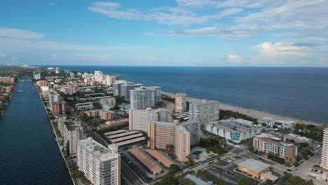 Aerial-View,-Pompano-Beach-FL-USA-Cityscape-Skyline,-Beachfront-Buildings,-Canal-and-Ocean-Horizon,-Drone-Shot