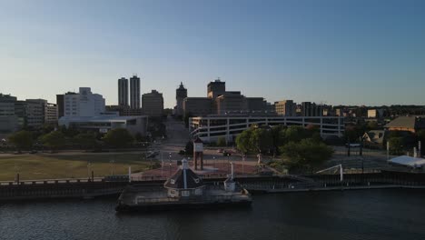 Beautiful-aerial-of-downtown-Peoria,-Illinois-with-bridge-connecting-to-East-Peoria,-Illinois-at-sunset