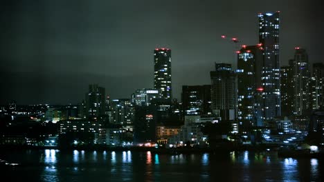 Nightime-time-lapse-of-Modern-buildings-at-London-Skyline,-Waterfront-Skyscrapers,-City-lights