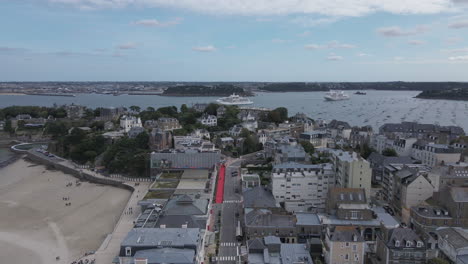 Drone-flying-over-Dinard-city-with-tourist-port-in-background,-Brittany-in-France
