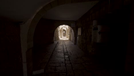 Walking-Through-Dark-Tunnel-Archway-At-Western-Wall-In-The-Old-City-of-Jerusalem-In-Israel